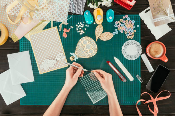 istock cropped image of designer taking sequins for scrapbooking postcard decoration 891306412