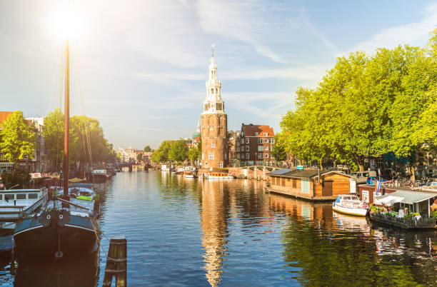 istock Amsterdam Canal with houseboats and ships 891306422