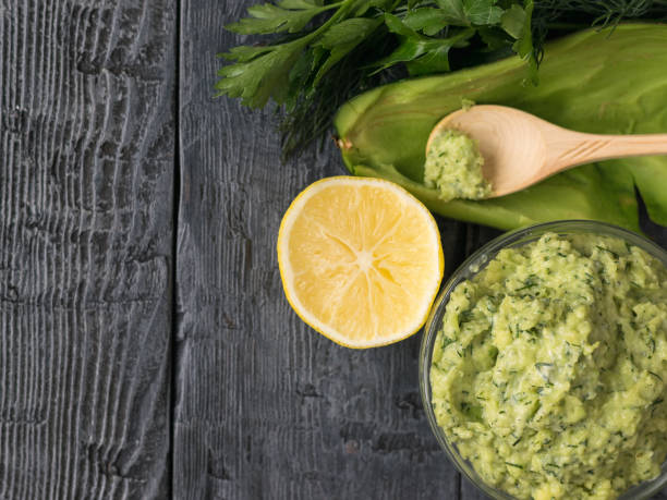 istock Half lemon and avocado pate with herbs on a rustic table. Top view. View from above. 891307168
