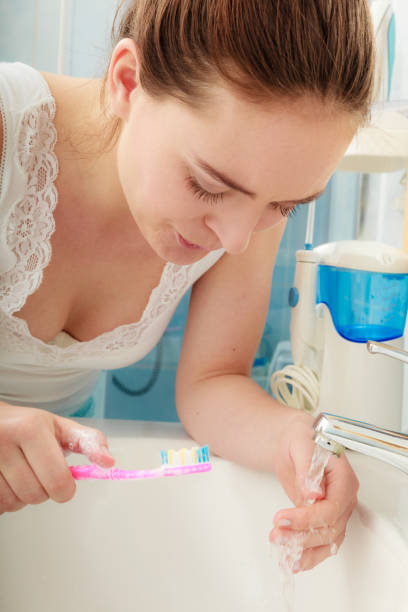 istock Woman brushing cleaning teeth. Oral hygiene. 891315314