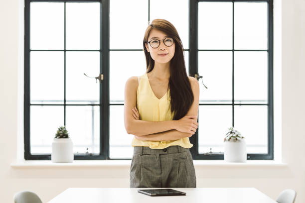 istock Young Female Chinese Leader Standing in Office 891318288
