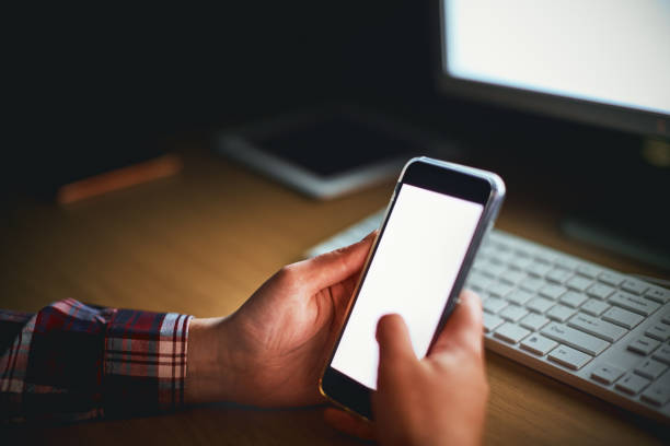 istock Female hand holding smartphone with screen lit. Nighttime shot. 891318370