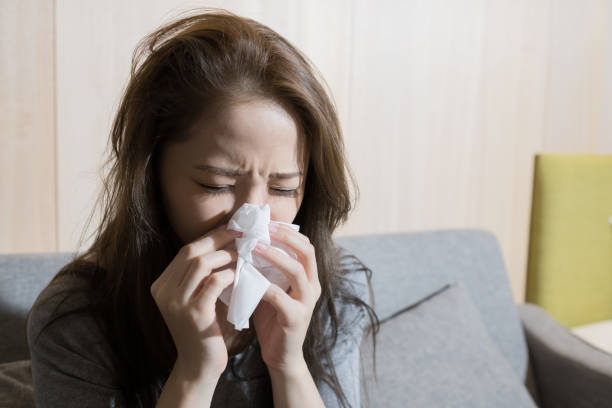 istock woman sick and sneezing 891319510