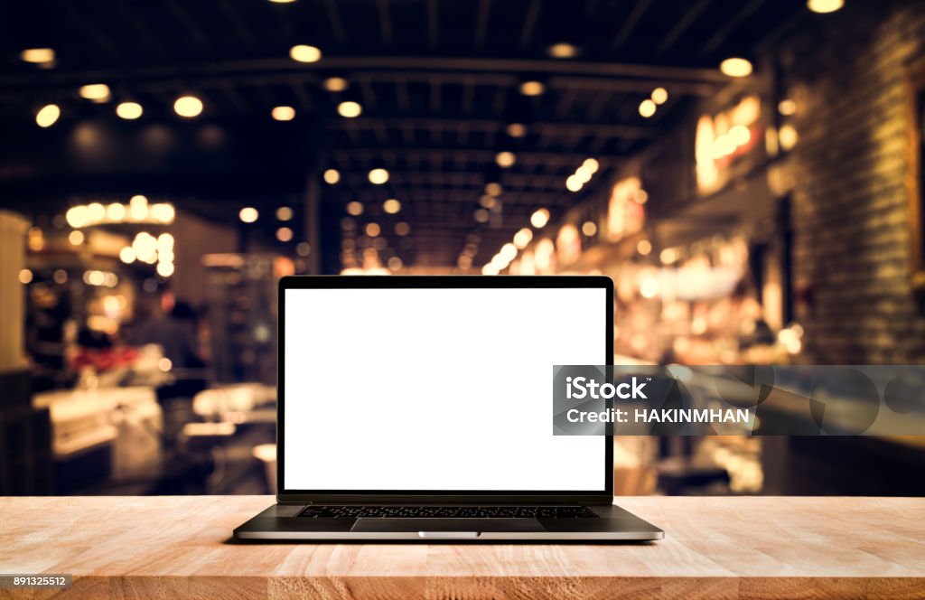 Modern computer,laptop with blank screen on table cafe shop Modern computer,laptop with blank screen on table cafe shop backgrounds Restaurant Stock Photo