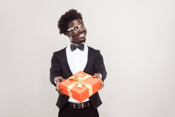 istock Romantic african businessman showing gift box for valentines day 891326550