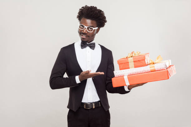 istock Valentine day concept. African businessman pointing hand at red box. 891326574