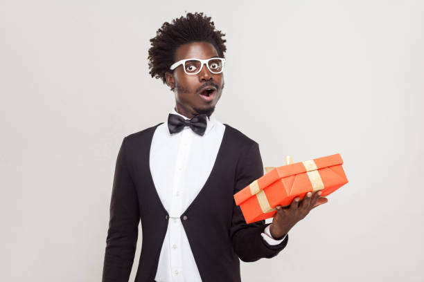 istock Amazement man holding gift box and shocked. 891326598
