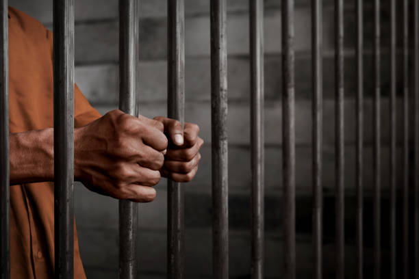 Man in prison Man in prison jail stock pictures, royalty-free photos & images