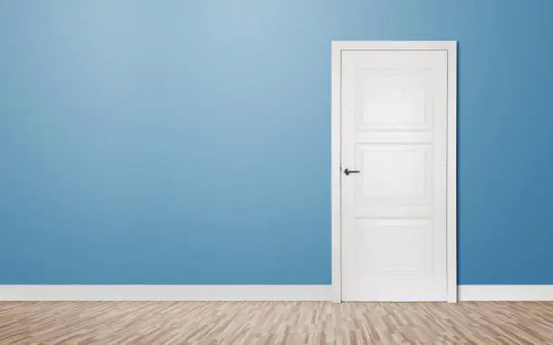 Close up of closed wooden door in the empty room with copy space