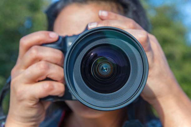 istock Close up woman photographing with camera 891337576