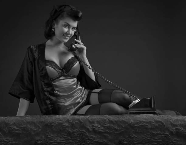 Beautiful woman in retro style. Beautiful woman in lingerie with perfect hair and make up , speaking via vintage phone. pin up girl photos stock pictures, royalty-free photos & images