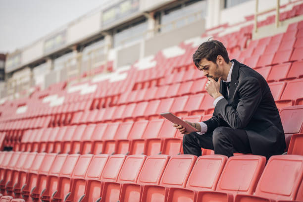 istock Coach sitting on the bleachers 891340436