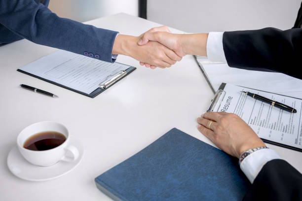 istock greeting new colleagues, Handshake while job interviewing, male candidate shaking hands with Interviewer or employer after a job interview, employment and recruitment concept 891341338