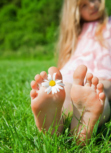 feet of a child on green grass