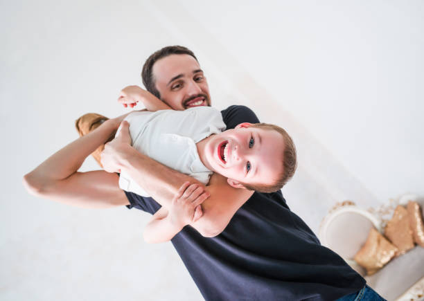 istock Small boy is sitting on his father's shoulders 891345492