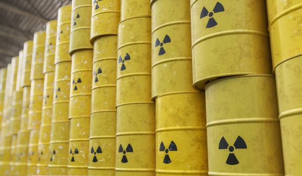 Dumping of radioactive waste barrels. 3D rendered illustration. stock photo