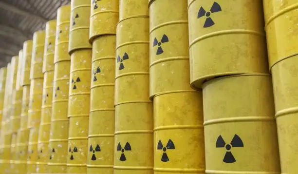Photo of Dumping of radioactive waste barrels. 3D rendered illustration.