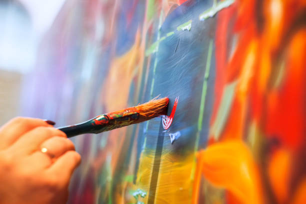 istock painting brush on wall 891352134