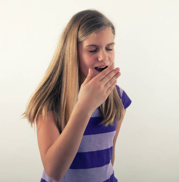istock young girl yawning 891352430