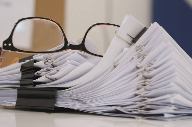 istock Glasses placed on finished document at workplace in morning 891352502