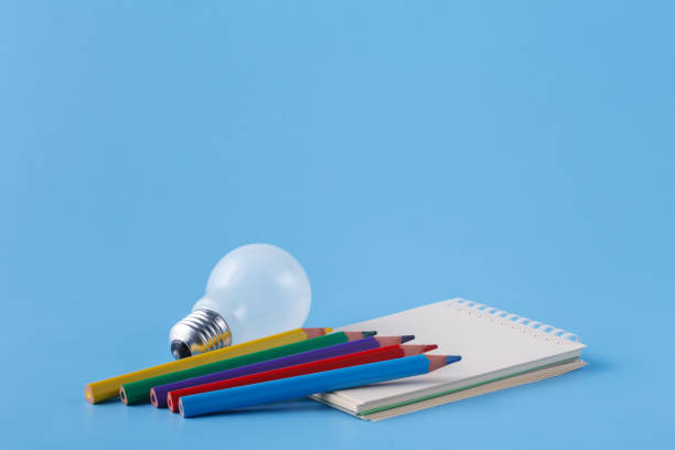istock Pile of colour pencils on light blue background, creative idea concept 891353300