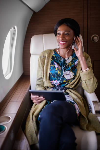 istock Woman in private jet airplane 891357288
