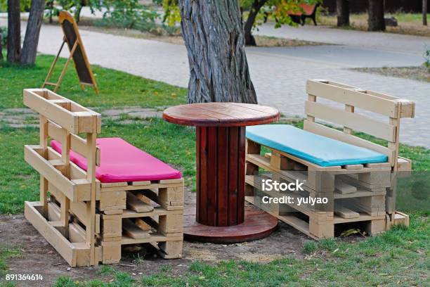 Wooden Bench Made Of Pallets For Sitting With Table Made From Coil Of Electric Cable Stock Photo - Download Image Now