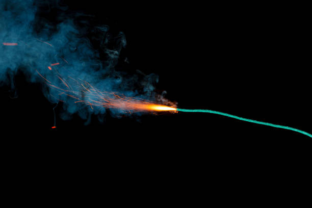 istock Burning fuse with sparks and blue smoke isolated on black background 891365016