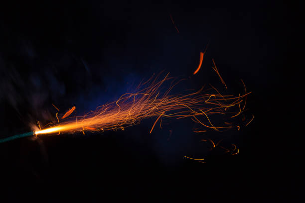 istock Burning fuse with sparks and blue smoke on black background 891367284