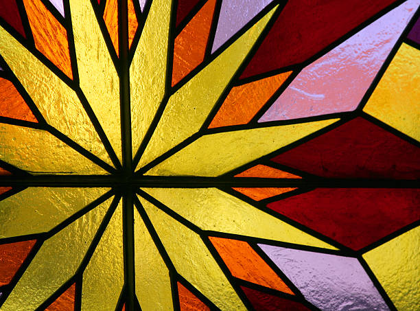 Colourful stained glass windows in a Catholic church in the town of Gratot in Normandy, France