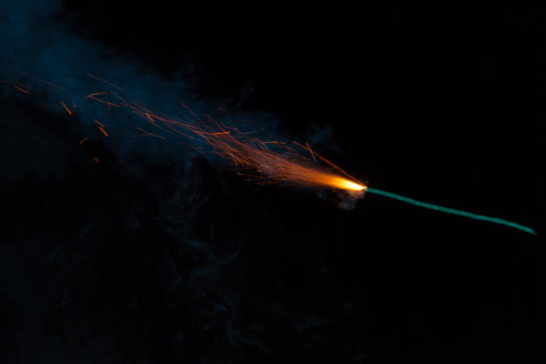 istock Burning fuse with sparks and blue smoke on black background 891380488