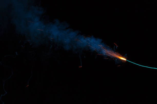 istock Burning fuse with sparks and blue smoke on black background 891380672