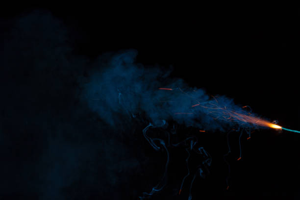 istock Burning fuse with sparks and blue smoke on black background 891381176