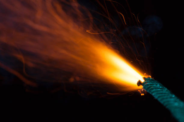 Burning fuse with sparks on black background Burning fuse with sparks on black background firework explosive material photos stock pictures, royalty-free photos & images