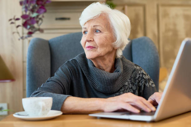istock Elegant Senior Woman Using Laptop 891382658