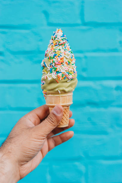 istock Holding ice cream against blue wall 891382712
