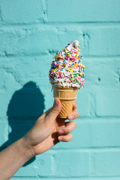 istock Holding ice cream against blue wall 891382720