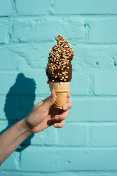 istock Holding ice cream against blue wall 891382722