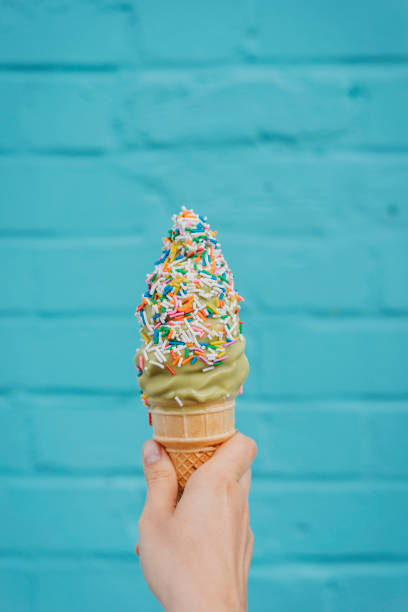 istock Holding ice cream against blue wall 891382728