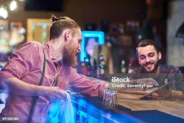 Bartender Helping Guest Choosing Drinks Stock Photo - Download Image Now - Bartender, Customer, Pub