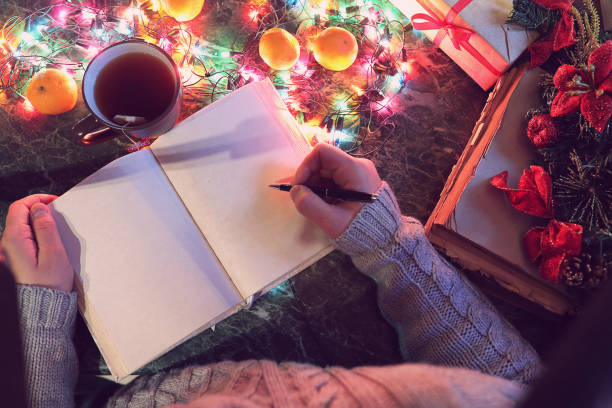 istock man with a blank book in his hands for the New Year's table with 891385686