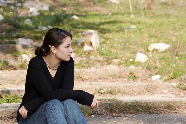 Pretty thoughtful girl in nature stock photo