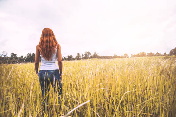 istock Asian women. On a meadow nice atmosphere during the summer. 891392446