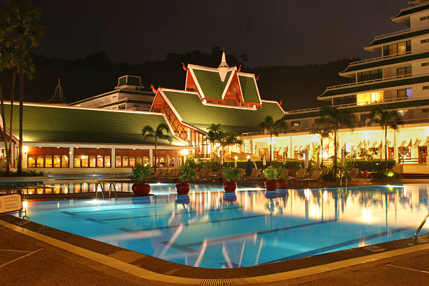 pool in phuket - ornamental garden flower bed night illuminated stock-fotos und bilder