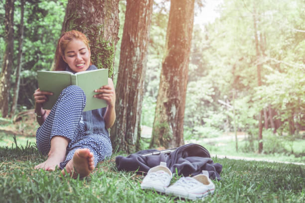 istock Read women relax in the park, pine forest, holiday forest. 891404156