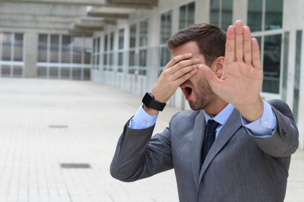 Denial concept with businessman covering his eyes stock photo