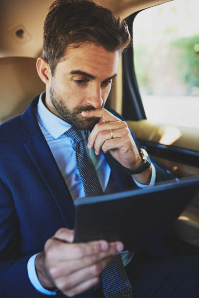 istock Even when he's in a car he works 891408760