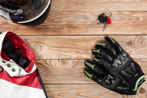istock View of motorcycle rider accessories placed on rustic wooden table. 891408824