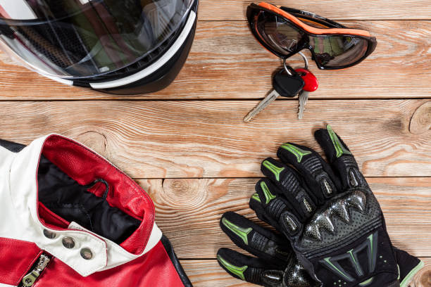 istock View of motorcycle rider accessories placed on rustic wooden table. 891411262
