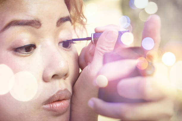 istock Women are making up. Eye liner black. Have bokeh 891411858